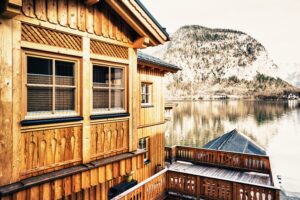 beautiful-shot-small-village-surrounded-by-lake-snowy-hills.jpg